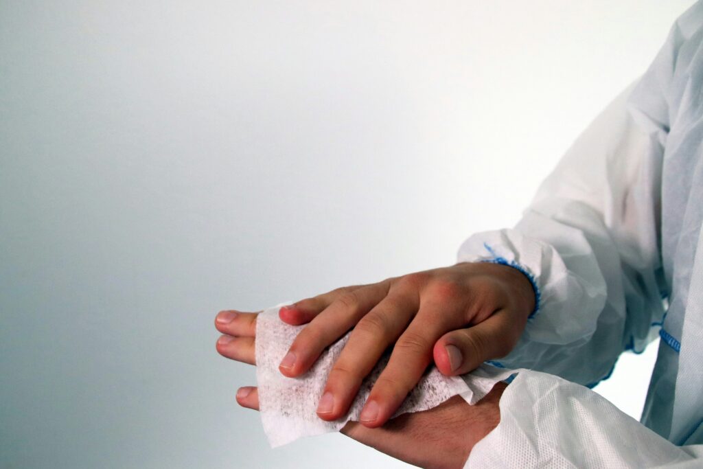 Healthcare professional holding a patient's hand during care